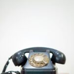 black rotary phone on white table